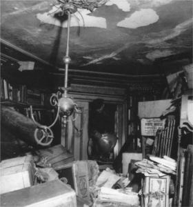 Figure 1: A New York City policeman climbs over debris to enter the junk-filled library in the Collyer house during a search for Langley Collyer (2).